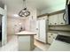 Well-lit kitchen featuring an island, white appliances, and abundant cabinetry at 5711 Garden Lakes Palm, Bradenton, FL 34203