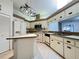 Functional kitchen with white cabinets, laminate countertops, and modern appliances at 5711 Garden Lakes Palm, Bradenton, FL 34203