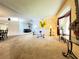 Inviting living room with large window, neutral carpeting, and bright walls at 5711 Garden Lakes Palm, Bradenton, FL 34203