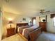 Relaxing main bedroom with ceiling fan, warm lighting, and traditional furnishings at 5711 Garden Lakes Palm, Bradenton, FL 34203