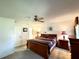 Comfortable main bedroom with natural light, ceiling fan, and ensuite bathroom access at 5711 Garden Lakes Palm, Bradenton, FL 34203