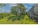 Expansive backyard featuring mature trees, green lawn, and vibrant landscaping enhancing the outdoor space at 5934 Guarino Dr, Sarasota, FL 34238