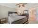 Bedroom features a ceiling fan, neutral walls and carpeting, and an en suite bathroom with glass shower at 5934 Guarino Dr, Sarasota, FL 34238