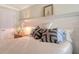 Comfortable bedroom with white paneling and decorative pillows on the bed at 5934 Guarino Dr, Sarasota, FL 34238