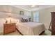 Cozy bedroom with a comfortable bed, ceiling fan and plantation shutters at 5934 Guarino Dr, Sarasota, FL 34238
