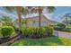 Charming single-Gathering home with a two-car garage, lush landscaping, and beautiful mature palm trees at 5934 Guarino Dr, Sarasota, FL 34238