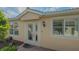 Inviting front entryway with glass-paneled door and sidelight, enhancing curb appeal and natural light at 5934 Guarino Dr, Sarasota, FL 34238