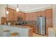 Spacious kitchen boasts stainless appliances, granite countertops, breakfast bar, tile backsplash, and ample cabinet space at 5934 Guarino Dr, Sarasota, FL 34238