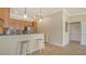 Eat-in kitchen features wood cabinetry, stainless appliances, granite counters and backsplash, and breakfast bar seating at 5934 Guarino Dr, Sarasota, FL 34238