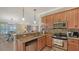 Open kitchen features stainless steel appliances, granite counters, breakfast bar, and is open to the dining and living room at 5934 Guarino Dr, Sarasota, FL 34238