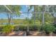 Screened patio showing a lake view with lush green landscaping at 5934 Guarino Dr, Sarasota, FL 34238