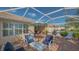 Covered lanai with comfortable seating and a lovely view of the backyard at 5934 Guarino Dr, Sarasota, FL 34238