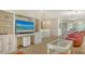 Open-concept living space with tile flooring, offering seamless flow between living, dining, and kitchen areas at 5934 Guarino Dr, Sarasota, FL 34238
