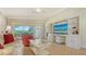 Inviting living room with tile flooring, custom built-ins, and a sliding glass door to the lanai at 5934 Guarino Dr, Sarasota, FL 34238
