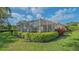 Enclosed patio area surrounded by manicured hedges, offering privacy and outdoor enjoyment at 5934 Guarino Dr, Sarasota, FL 34238