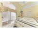Sunlit bedroom featuring sliding glass doors to a balcony, a ceiling fan and a TV at 7507 Preserves Ct # 7507, Sarasota, FL 34243