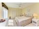 Cozy bedroom featuring neutral decor, a ceiling fan, and a comfortable wicker bed frame at 7507 Preserves Ct # 7507, Sarasota, FL 34243