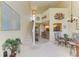 Open-concept dining area adjacent to kitchen featuring modern chandelier lighting and a staircase at 7507 Preserves Ct # 7507, Sarasota, FL 34243
