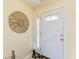 A bright entryway features a decorative mirror, a decorative sculpture and a glass paneled door at 7507 Preserves Ct # 7507, Sarasota, FL 34243