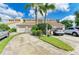 Townhome complex featuring well-manicured lawns, palm trees, and ample parking at 7507 Preserves Ct # 7507, Sarasota, FL 34243