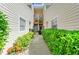 Townhome walkway with lush greenery, leading to a private balcony at 7507 Preserves Ct # 7507, Sarasota, FL 34243