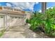 Beige townhome showcasing a garage and lush landscaping, with a walkway leading to the front door at 7507 Preserves Ct # 7507, Sarasota, FL 34243