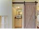 This condo features a charming kitchenette with granite counters and a barn door at 7507 Preserves Ct # 7507, Sarasota, FL 34243