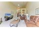 Spacious living room featuring comfortable leather sofas and open-concept design at 7507 Preserves Ct # 7507, Sarasota, FL 34243