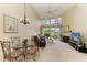 Bright living room with cathedral ceiling, fireplace, and a view of the golf course at 7507 Preserves Ct # 7507, Sarasota, FL 34243
