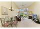 Bright living room with cathedral ceiling, fireplace, and a view of the golf course at 7507 Preserves Ct # 7507, Sarasota, FL 34243