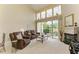 Spacious living room featuring comfortable leather sofas and a fireplace with golf course views at 7507 Preserves Ct # 7507, Sarasota, FL 34243