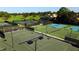 Multiple tennis courts available with green and blue surfaces surrounded by trees at 7507 Preserves Ct # 7507, Sarasota, FL 34243
