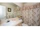 Inviting bathroom featuring a patterned shower curtain, a large mirror, and ample counter space at 7685 Plantation Cir # B, University Park, FL 34201