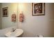 Well-lit half-bath featuring a sleek sink and tasteful decor at 7685 Plantation Cir # B, University Park, FL 34201