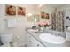 Well-lit bathroom featuring double sinks, white cabinets, and decorative artwork, providing a spa-like experience at 7685 Plantation Cir # B, University Park, FL 34201