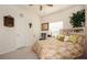 Charming bedroom with a floral bedspread, ceiling fan, and bright window, offering a comfortable retreat at 7685 Plantation Cir # B, University Park, FL 34201