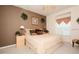 Warm bedroom with a light-filled window, earth tone walls, and plush bedding, providing an inviting space at 7685 Plantation Cir # B, University Park, FL 34201
