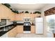 Efficient kitchen featuring granite countertops, neutral cabinets, and tiled floor at 7685 Plantation Cir # B, University Park, FL 34201