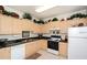 Efficient kitchen featuring granite countertops, neutral cabinets, and tiled floor at 7685 Plantation Cir # B, University Park, FL 34201