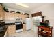 Well-lit kitchen featuring granite countertops, neutral cabinets, and appliances at 7685 Plantation Cir # B, University Park, FL 34201