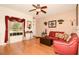 Bright and airy living room boasts hardwood floors, a ceiling fan, and comfortable seating for a welcoming ambiance at 7685 Plantation Cir # B, University Park, FL 34201