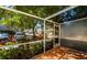 Inviting screened-in patio with tiled flooring and serene views of landscaping, a great spot to unwind at 7685 Plantation Cir # B, University Park, FL 34201