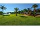 Community playground with slides and lush landscaping near a pond with a fountain at 7685 Plantation Cir # B, University Park, FL 34201