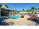 Inviting community pool surrounded by lounge chairs and well-maintained landscaping at 7685 Plantation Cir # B, University Park, FL 34201