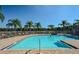 Resort-style swimming pool with lounge chairs and tropical landscaping at 7685 Plantation Cir # B, University Park, FL 34201