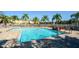 Community pool with lounge chairs offers a relaxing area at 7685 Plantation Cir # B, University Park, FL 34201