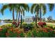 Elegant community entrance sign amid colorful flowers and palm trees at 7685 Plantation Cir # B, University Park, FL 34201