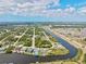 Scenic aerial shot showcases the waterfront community, featuring well-maintained homes along the tranquil canal at 8058 Santa Cruz Dr, Port Charlotte, FL 33981