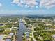 Expansive aerial view of a waterfront community with beautiful homes and scenic canals under a partly cloudy sky at 8058 Santa Cruz Dr, Port Charlotte, FL 33981