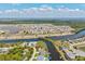 Overhead view of a waterfront community with a winding canal, showcasing a mix of homes and natural landscape at 8058 Santa Cruz Dr, Port Charlotte, FL 33981